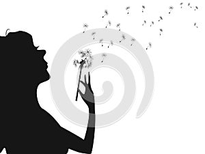 Woman blowing dandelion