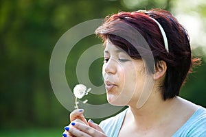 Woman Blowing Dandelion