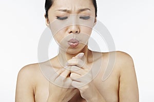 Woman blowing on finger injury. Conceptual image