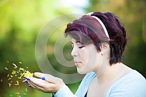 Woman Blowing Flower Petals