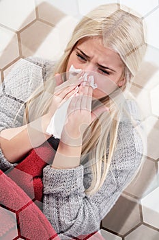 Woman blowing her nose