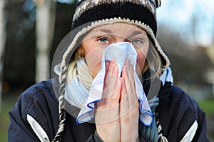 Woman blowing her nose