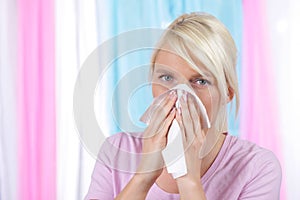 Woman blowing her nose