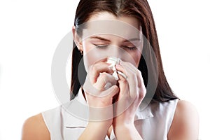 Woman blowing her nose