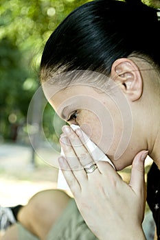 Woman blowing her nose