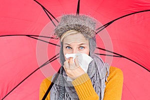 Woman blowing her nose with a tissue