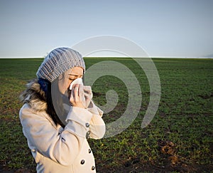 Woman blowing nose