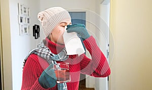 Woman blowing nose as cold season concept
