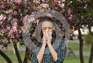 Woman blowing nose because of spring pollen allergy