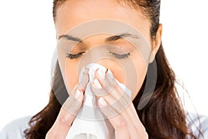 Woman blowing nose with tissue paper