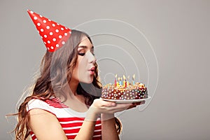 Woman blowing out candles