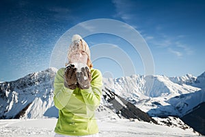 Woman blowing on snow