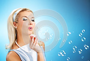 Woman blowing soap bubbles