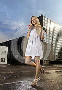 Woman blowing soap bubbles on street