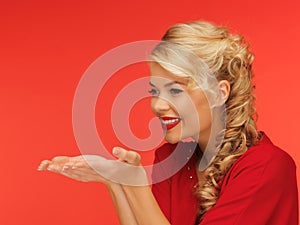 Woman blowing something on the palms of her hands