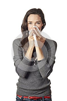 Woman blowing or wiping her nose