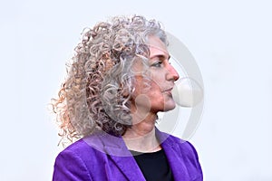 Woman blows bubbles with chewing gum