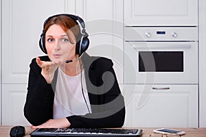 A woman blows a kiss during an online conference at a remote job from home. Businesswoman talks in a video call in an Internet