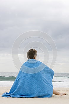 Woman with blue blanket on beach photo
