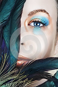 Woman with blue and bronze make-up