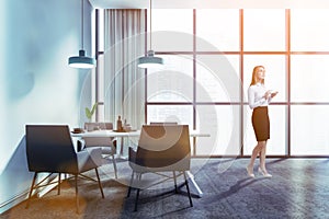 Woman in blue dining room interior