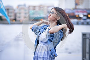 Woman in blue dress doing hair flip