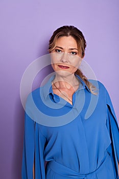 Woman in blue dress on purple background