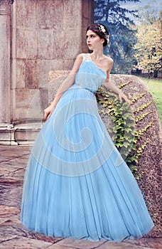 Woman in blue dress, in the secret garden