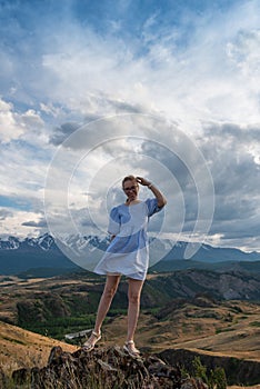 Woman in blue dress in summer Altai mountains