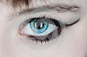 Woman with blue eye staring at you