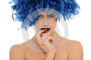 Woman in blue feathers with open eyes