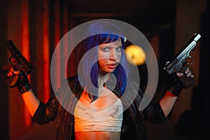 woman with blue hair holding two guns and looking as killer