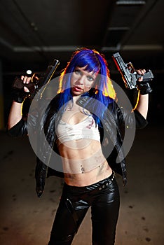 woman with blue hair holding two guns and looking as killer