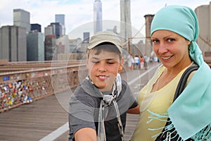 A woman in a blue headscarf with her son on the photo