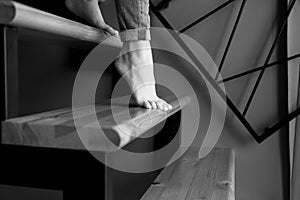 Woman in blue jeans go down in stairs.