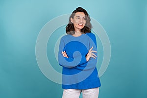 Woman in a blue knitted sweater and natural make-up, curly short hair