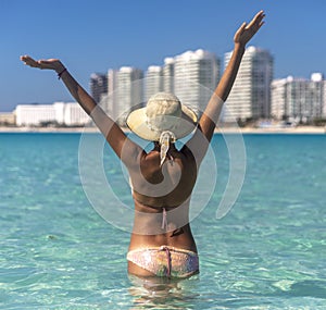 Woman on blue seagull beach in Cancun in Riviera Maya of Mexico. Turquoise caribbean beach with white sand.