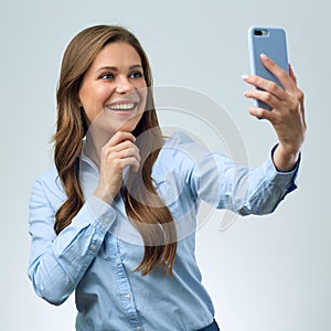 Woman in blue shirt making selfportrait with smartphone