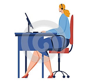 Woman in blue sweater working at computer desk wearing headset. Female call center agent or customer service