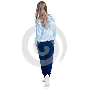 Woman in blue sweatpants sport style casual goes walking