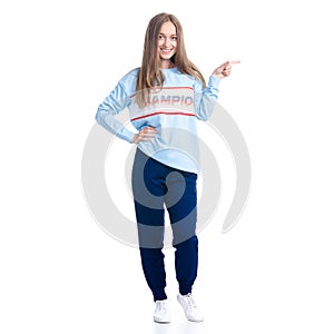 Woman in blue sweatpants sport style casual standing looking smiling showing pointing