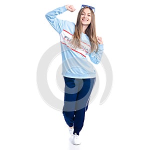 Woman in blue sweatpants with sunglasses sport style casual dancing smiling