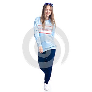 Woman in blue sweatpants with sunglasses sport style casual goes walking smiling