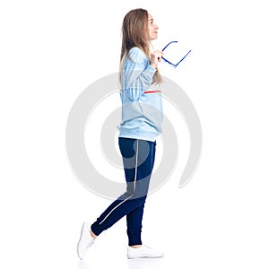 Woman in blue sweatpants with sunglasses sport style casual goes walking smiling