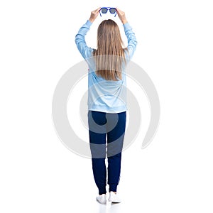 Woman in blue sweatpants with sunglasses sport style casual standing looking