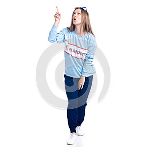 Woman in blue sweatpants with sunglasses sport style casual standing smiling happiness showing pointing