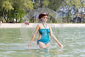 Woman in blue swimsuit relax in sea water