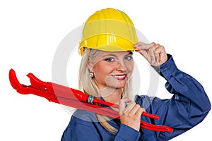 Woman in blue work clothes with pipe wrench