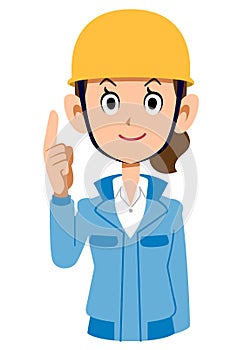 Woman in blue workwear wearing a helmet pointing up