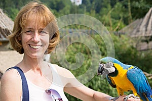 Woman with blue-and-yellow macaw